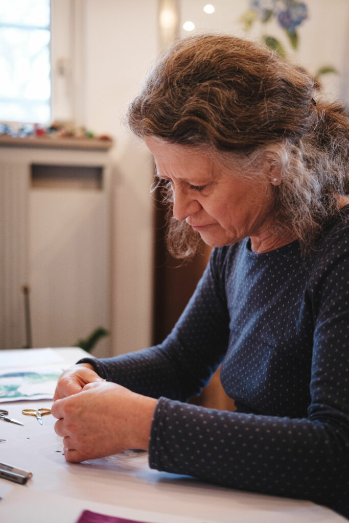 Angelika Kiesewetter-Lorenz fotografiert von der Seite beim Scherenschnitt